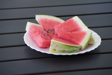 Ripe red water melon on the white plate
