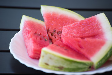 Ripe red water melon on the white plate