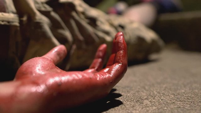 Injured Young Male's Hand Shaking with Dark Red Blood