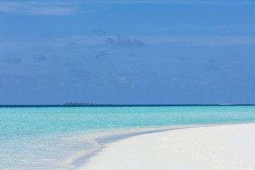 Fototapeta na wymiar Tropical sand beach and blue sky with white clouds