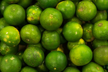 Bunch of fresh green mandarin in the organic food market. Tropical Bali island, Indonesia.