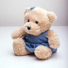 Little toy bear in a blue dress