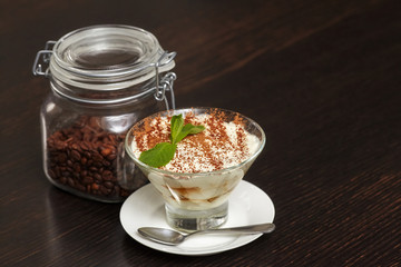 Tiramisu creme cake dessert in glass with mint leaves