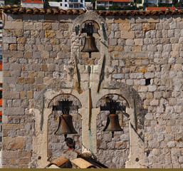 Antique stone bell tower with three bells in Dubrovnik