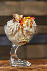 Ice cream cocktail in bowl with syrup and other treats