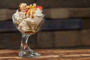 Ice cream cocktail in bowl with syrup and other treats