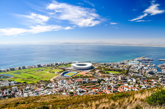 Beautiful view of Mouille Point, Green Point with Cape Town Stadium and the V&A (Victoria and Alfred) Waterfront in Cape Town seen from Signal Hill. Sunny day with a few clouds. South Africa.