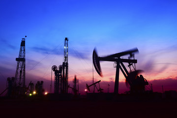 Pumping unit in the work, under the background of the setting sun