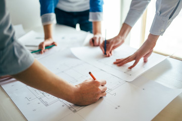 Close up of construction engineers hands working on project