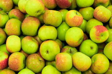 Background of apples on sale at the local organic market of tropical Bali island, Indonesia.