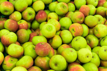 Background of apples on sale at the local organic market of tropical Bali island, Indonesia.