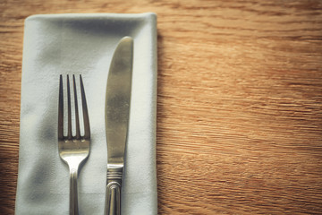 Fork and knife on a table, on a napkin