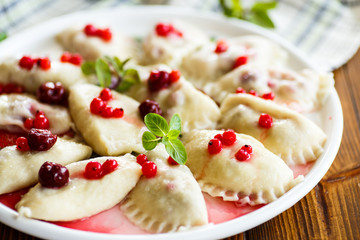 Sweet boiled dumplings with cherries and berries