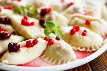 Sweet boiled dumplings with cherries and berries