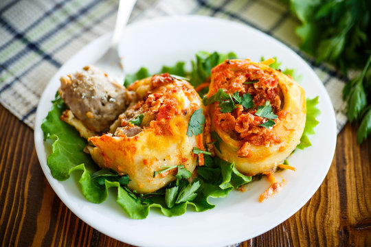 Traditional stewed manti in tomato sauce