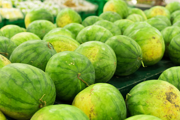 Many big sweet green watermelons sell on market. Local organic market on tropical Bali, Indonesia. Watermelon background.