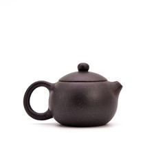Retro clay Chinese teapot isolated on a white background. small earthenware