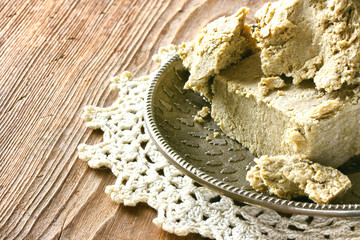 Sunflower halva, oriental sweets, slices on a metal plate