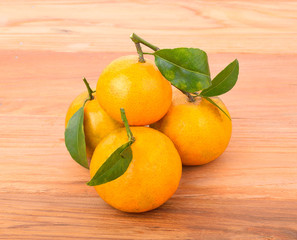 Fresh oranges on a wooden floor.