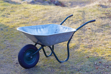 Empty wheelbarrow, grass in the background