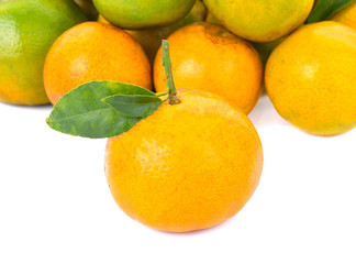 Ripe tangerine with leaf on a white background.
