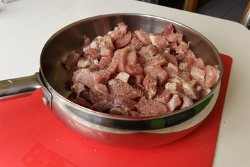 Fresh raw pork with spicy in a hot steel frying pan