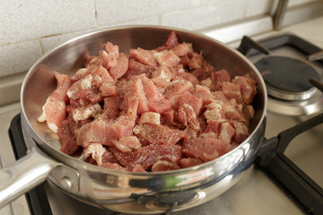 Fresh raw pork with spicy in a hot steel frying pan