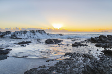 Water flowing down the rock during sunrise at Currumbin Rock Gold Coast.