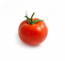 Photo depicts a bright red color natural beautiful delicious single fresh tomato with water drops, isolated on a white background. Washed vegetable concept. Close up, top view.