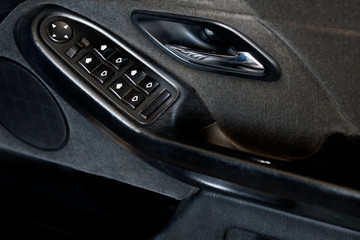 Fototapeta na wymiar Control panel on the armrest of the car door