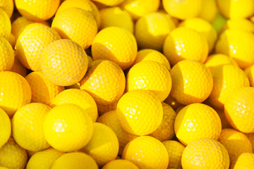 Close-up picture of yellow golf balls pile