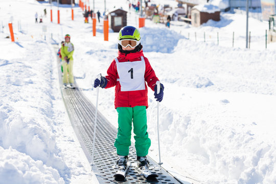 Portrait Of Kid Boy Going Uphill Using Ski Lift