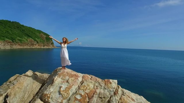 Young Fresh Woman in White Dress on Top of Mountain