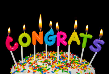 congrats candles on cake with colorful sprinkles