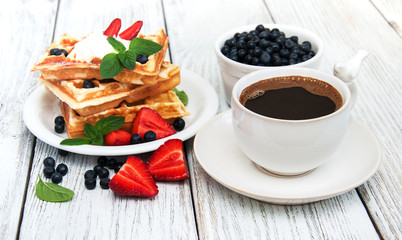 waffles with strawberries,  blueberry and coffee