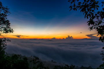 Beautiful summer sunrise on the top of mountain with Rays of Light, fog and cloud mountain