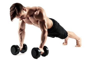 Muscular bodybuilder guy doing Push-ups on dumbbells from the floor over white background