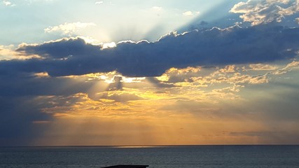 sun behind clouds