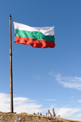 National flag of Bulgaria on metal pole against blue sky
