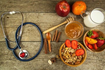 Stethoscope and oatmeal with strawberries. The concept of healthy eating. Diet food.