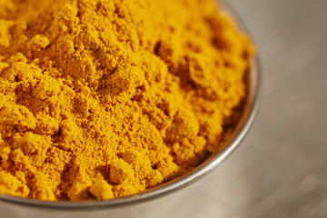 a small bowl of ground turmeric