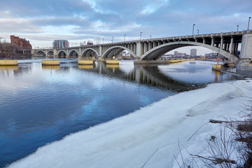 Mississippi River in winter with snow and white bridge