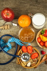 Stethoscope and oatmeal with strawberries. The concept of healthy eating. Diet food.