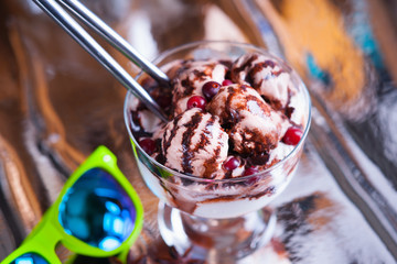 Ice cream sundae, spoons and sun glasses