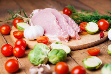 Slices of raw pork meat and vegetables 