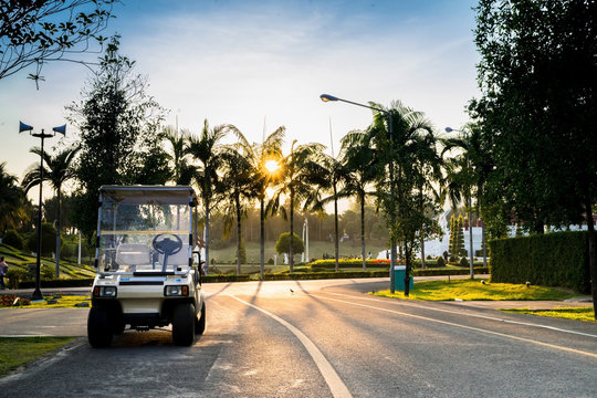 Golf Car In The Garden At Sunset