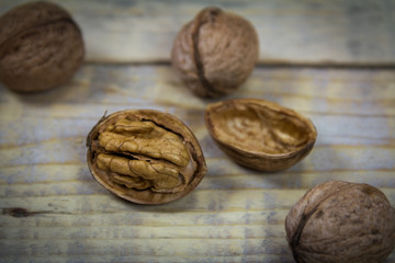 Shelled and peeled nuts on a wooden background