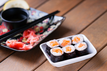 Sushi rolls with salmon, soy sauce and chopsticks 
