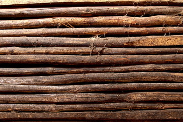 old wooden fence of logs in form of palisade