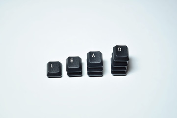 Obraz na płótnie Canvas Keys taken from keyboard to form the word LEAD, 